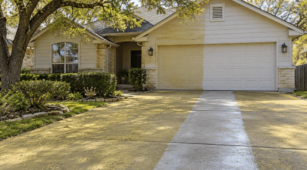 San Antonio home with a yellow pollen film on the driveway and siding